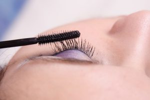 Makeup artist tints lashes mascara