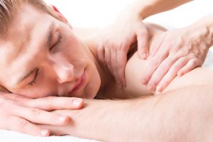 Handsome man enjoying a deep tissue back massage.